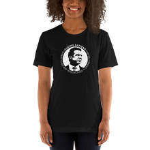 Load image into Gallery viewer, Woman wearing a black unisex t-shirt, featuring the Cuomo Sapiens S.U.D.L.T. SEAL graphic in white.