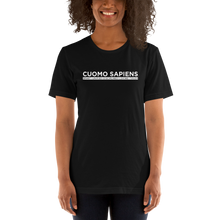 Load image into Gallery viewer, Woman wearing a black unisex t-shirt, featuring the Cuomo Sapiens S.U.D.L.T. graphic in white.
