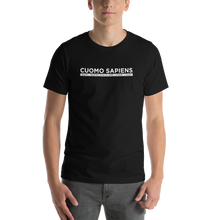 Load image into Gallery viewer, Man wearing a black unisex t-shirt, featuring the Cuomo Sapiens S.U.D.L.T. graphic in white.