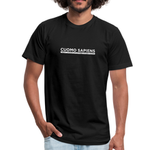 Load image into Gallery viewer, Man wearing a black unisex t-shirt, featuring the Cuomo Sapiens S.U.D.L.T. graphic in white.
