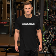 Load image into Gallery viewer, Man at the gym, wearing a black unisex t-shirt, featuring the Cuomo Sapiens S.U.D.L.T. graphic in white.