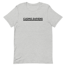 Load image into Gallery viewer, A heather grey unisex t-shirt on a flat surface, featuring the Cuomo Sapiens S.U.D.L.T. graphic in black.