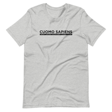 Load image into Gallery viewer, A heather grey unisex t-shirt lying wrinkled on a flat surface, featuring the Cuomo Sapiens S.U.D.L.T. graphic in black.