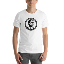 Load image into Gallery viewer, Man wearing a white unisex t-shirt, featuring the Cuomo Sapiens S.U.D.L.T. SEAL graphic in black.