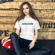 Load image into Gallery viewer, Woman with a motorcycle helmet next to some crates, wearing a white unisex t-shirt, featuring the Cuomo Sapiens S.U.D.L.T. graphic in black.