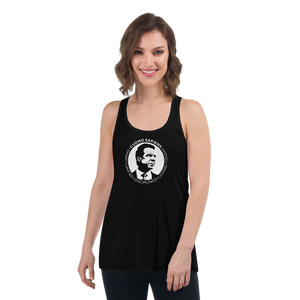 Woman wearing a black flowy racerback style tank top, featuring the Cuomo Sapiens S.U.D.L.T. SEAL graphic in white.