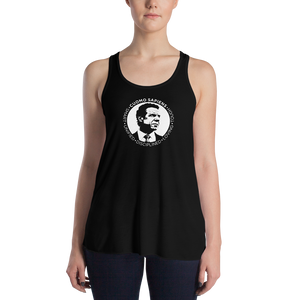 Woman wearing a black flowy racerback style tank top, featuring the Cuomo Sapiens S.U.D.L.T. SEAL graphic in white.
