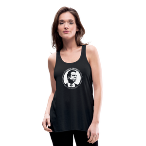 Woman wearing a black flowy racerback style tank top, featuring the Cuomo Sapiens S.U.D.L.T. SEAL graphic in white.