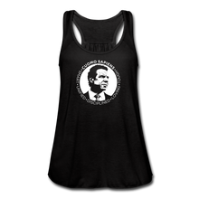 Load image into Gallery viewer, A women’s flowy, racerback style tank top, in black, on a transparent body form, featuring the Cuomo Sapiens S.U.D.L.T. SEAL graphic in white.
