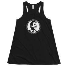Load image into Gallery viewer, A women’s flowy, racerback style tank top, in black, lying wrinkled on a flat surface, featuring the Cuomo Sapiens S.U.D.L.T. SEAL graphic in white.
