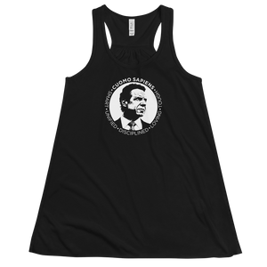 A women’s flowy, racerback style tank top, in black, lying wrinkled on a flat surface, featuring the Cuomo Sapiens S.U.D.L.T. SEAL graphic in white.