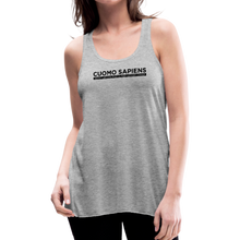 Load image into Gallery viewer, Woman wearing a heather grey flowy racerback style tank top, featuring the Cuomo Sapiens S.U.D.L.T. graphic in black.
