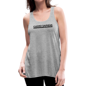 Woman wearing a heather grey flowy racerback style tank top, featuring the Cuomo Sapiens S.U.D.L.T. graphic in black.