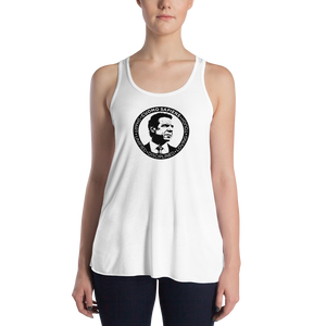 Woman wearing a white flowy racerback style tank top, featuring the Cuomo Sapiens S.U.D.L.T. SEAL graphic in black.