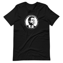 Load image into Gallery viewer, A black unisex t-shirt lying wrinkled on a flat surface, featuring the Cuomo Sapiens S.U.D.L.T. SEAL graphic in white.
