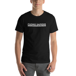 Man wearing a black unisex t-shirt, featuring the Cuomo Sapiens S.U.D.L.T. graphic in white.