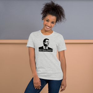 Woman standing against a wall, wearing a heather grey unisex t-shirt, featuring the Cuomo Sapiens NO BALONEY graphic in black.
