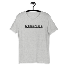 Load image into Gallery viewer, A heather grey unisex t-shirt on a hangar, featuring the Cuomo Sapiens S.U.D.L.T. graphic in black.
