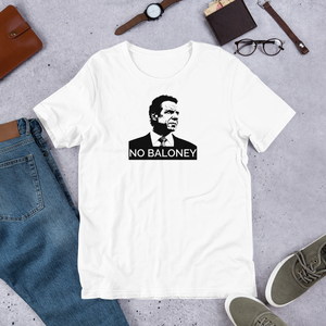 A white unisex t-shirt on the floor, featuring the Cuomo Sapiens NO BALONEY graphic in black.