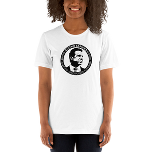 Woman wearing a white unisex t-shirt, featuring the Cuomo Sapiens S.U.D.L.T. SEAL graphic in black.