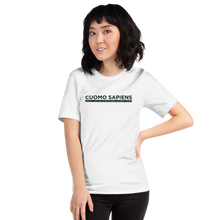Load image into Gallery viewer, Woman wearing a white unisex t-shirt, featuring the Cuomo Sapiens S.U.D.L.T. graphic in black.
